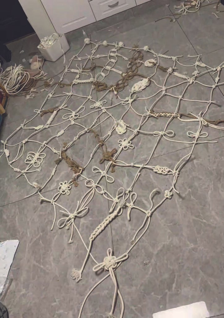 Cotton and jute ropes spread across the studio floor, gradually forming a loose, irregular web.