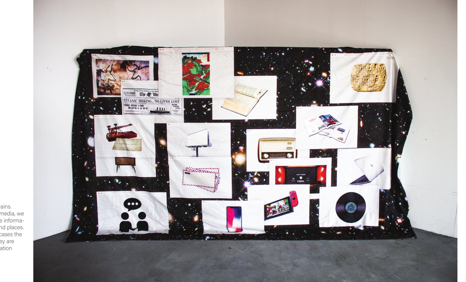 Fabric installation showing images of communication and media technologies against a galaxy-patterned field.